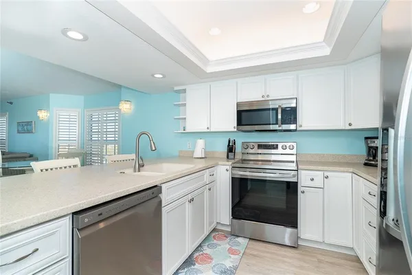 a kitchen with a sink stove and microwave
