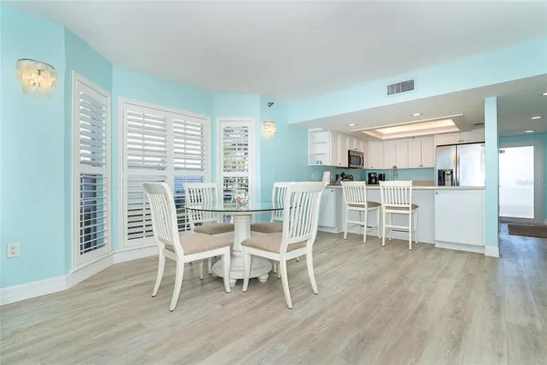 a dining room with furniture and wooden floor