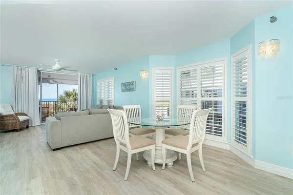 a dining room with furniture and wooden floor