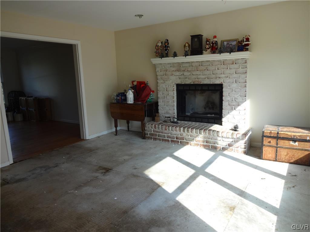 2311 Yost Road Bath, PA 18014 - Photo 11 of 21 a living room with furniture a fireplace and a flat screen tv