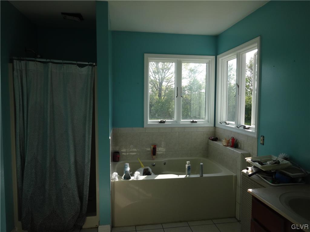 2311 Yost Road Bath, PA 18014 - Photo 19 of 21 a bath tub sitting in a bathroom next to a window