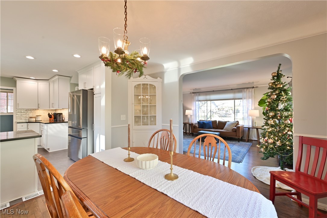 21887 Eaton Road Cleveland, OH 44126 - Photo 9 of 34 Dining area featuring dark wood-style flooring, recessed lighting, and arched walkways