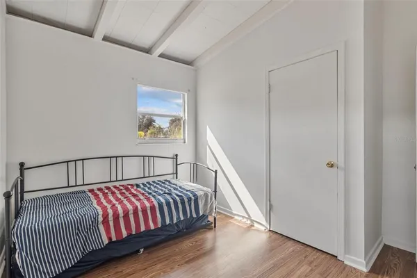 a view of bedroom with wooden floor