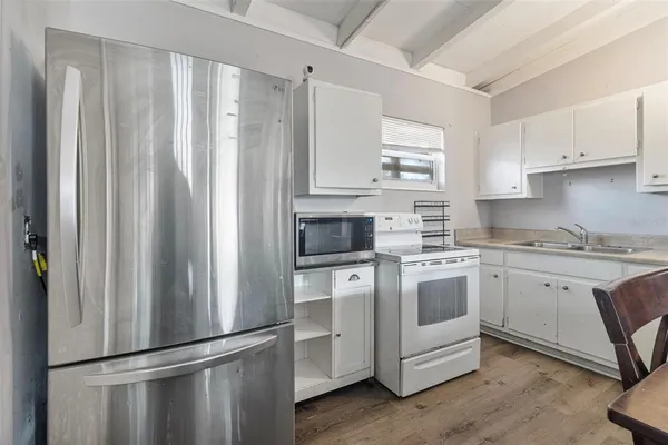 a kitchen with stainless steel appliances granite countertop a refrigerator sink and stove