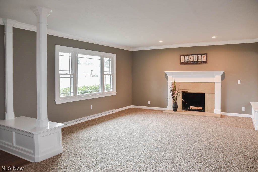340 Kenridge Road Akron, OH 44333 - Photo 2 of 21 The formal living room features columns, a picture window and a fireplace.