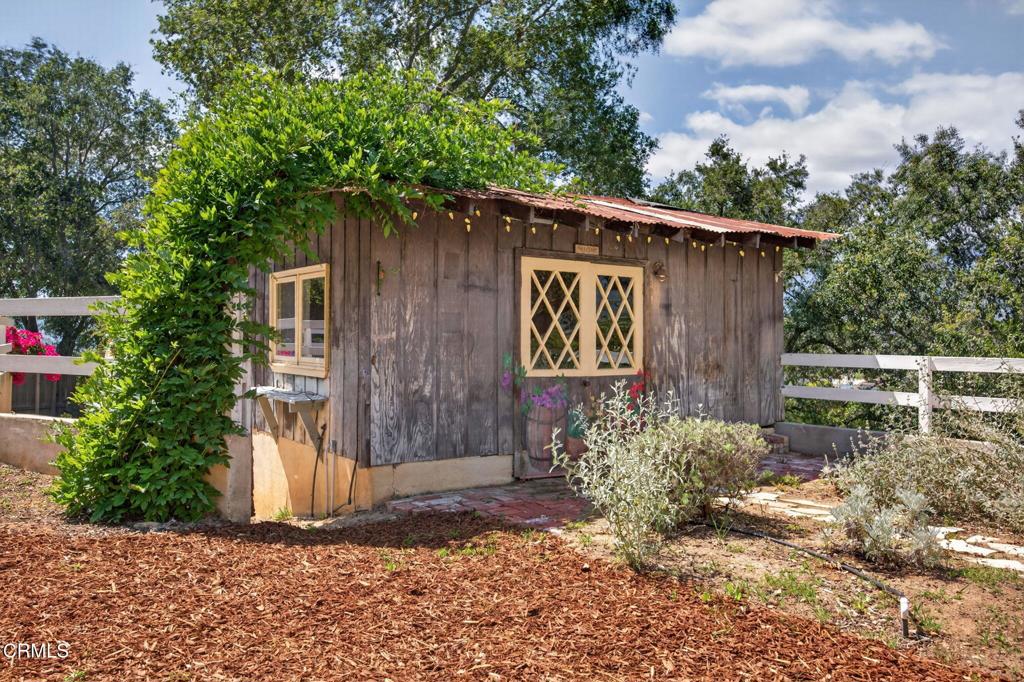 98 Howard Avenue Oak View, CA 93022 - Photo 45 of 72 a wooden house with a large tree in front of it