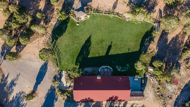 11550 Pigeon Hollow Road Spring City, UT 84662 - Photo 15 of 85 Expansive green lawn, fenced perimeter, surrounding natural landscaping, and red-roofed structure