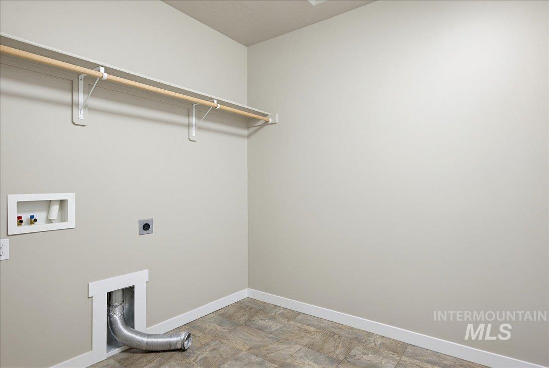 12460 West Azure Street Boise, ID 83713 - Photo 30 of 34 Dedicated utility space featuring a wood-finish hanging rod, neutral wall paint, and tiled flooring
