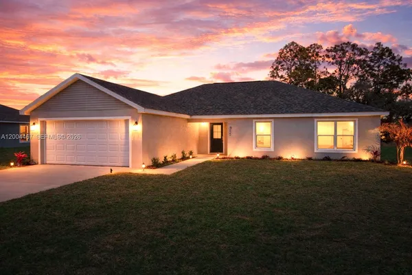 a front view of a house with a garden