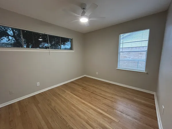 a view of an empty room and wooden floor