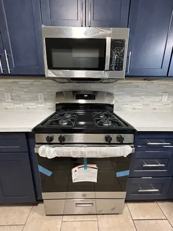 a stove top oven sitting inside of a kitchen