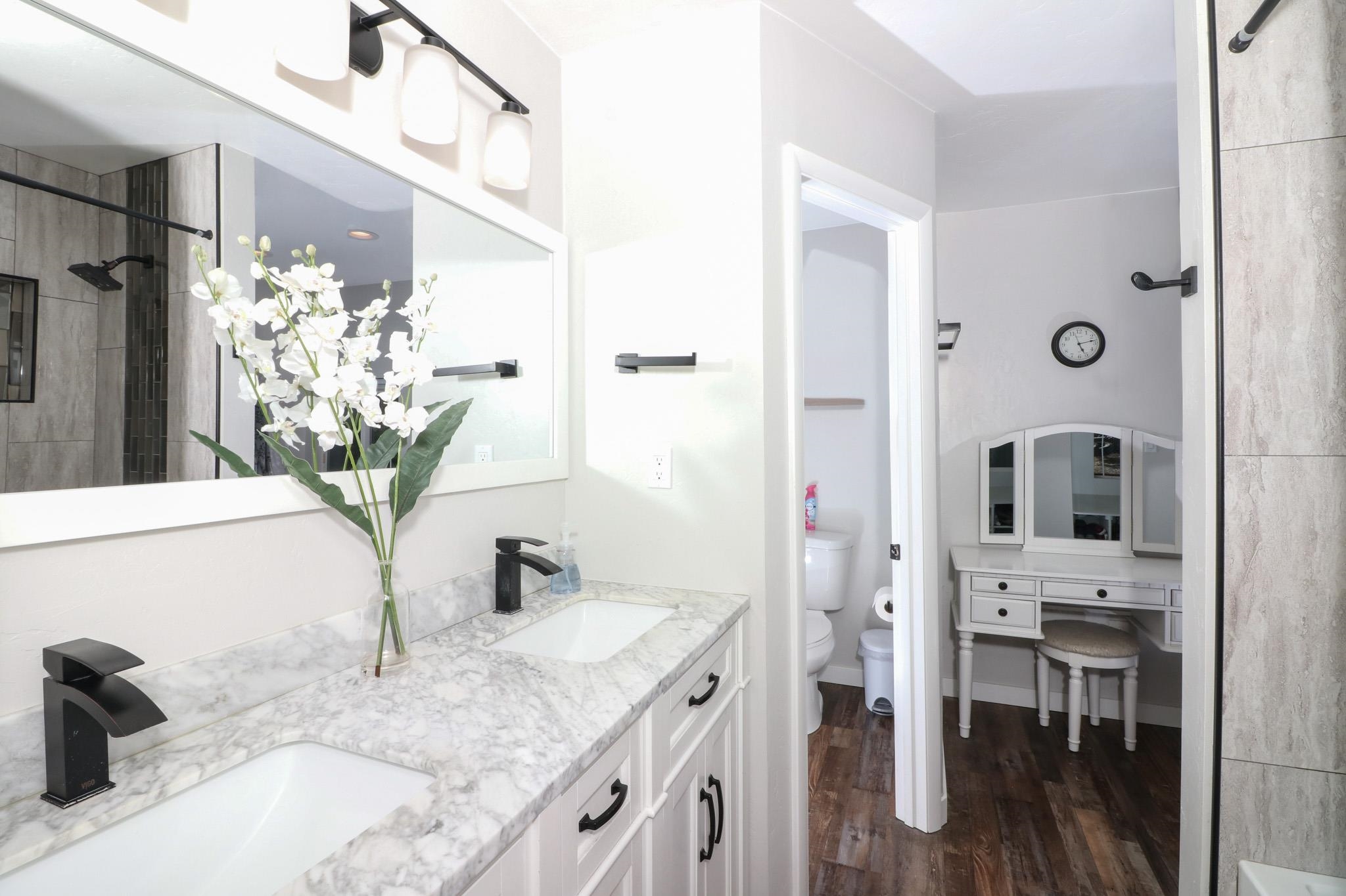 607-28 28 3/4 Road Grand Junction, CO 81506 - Photo 13 of 42 a bathroom with a granite countertop sink a mirror and a shower