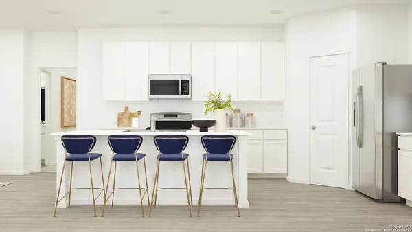 a kitchen with a dining table chairs and white appliances