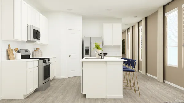 a kitchen with a sink cabinets and wooden floor