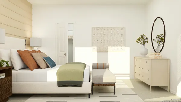 a bedroom with a bed a dresser and chair