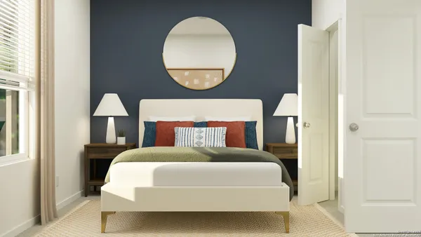 a bed room with a bed mirror and a window