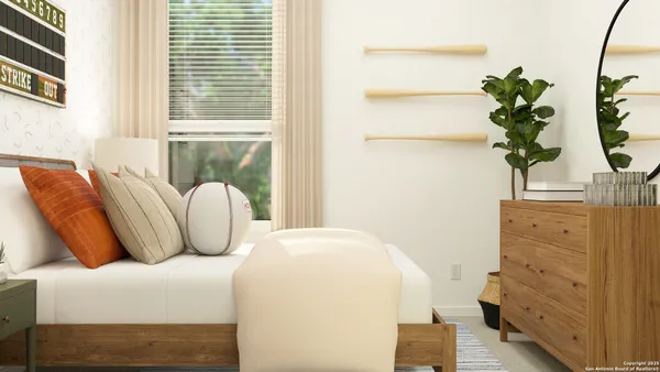 a bedroom with a bed and a potted plant