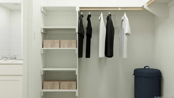 a view of walk in closet with clothes