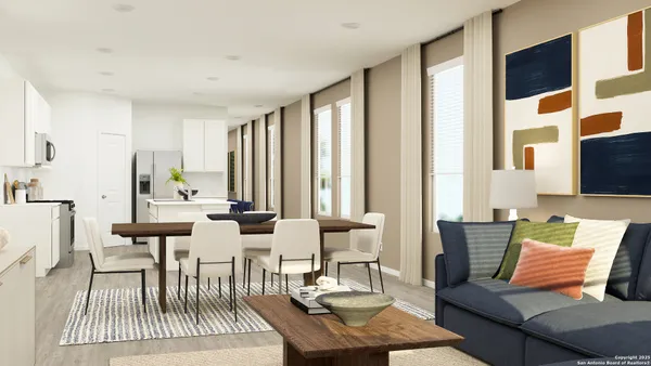 a living room with furniture and large windows