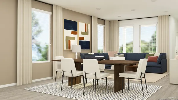 a dining room with furniture window and wooden floor