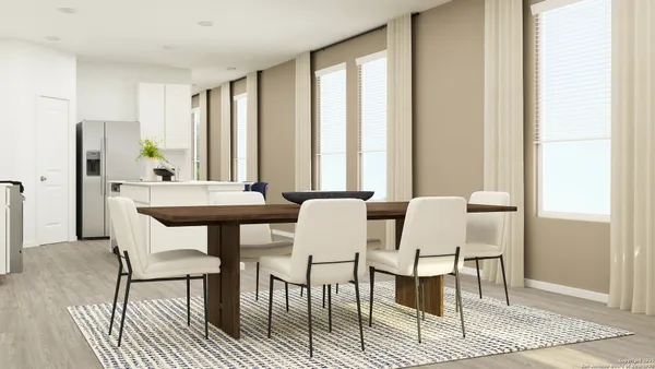 a view of a a dining room with furniture window and wooden floor