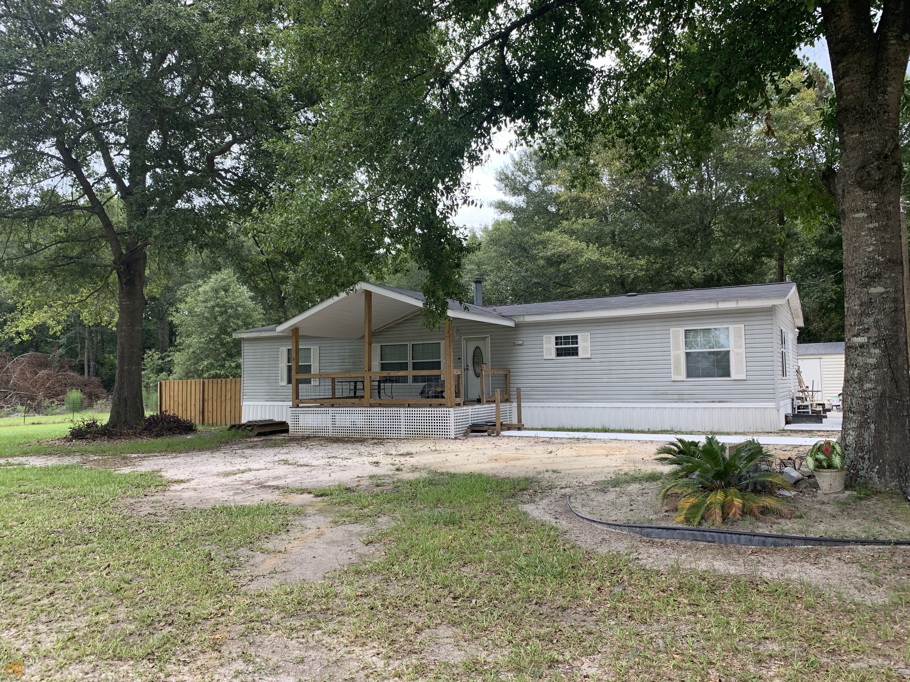 264 Clint Johnson Road Baxley, GA 31513 - Photo 1 of 1 a front view of a house with a yard and garage