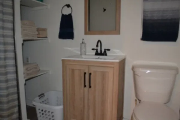 a bathroom with a sink a mirror and a window