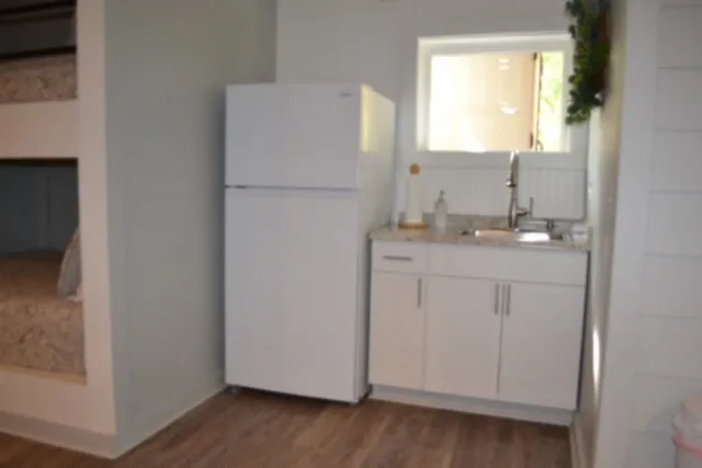 a bedroom with a large bed and a flat tv screen on a dresser