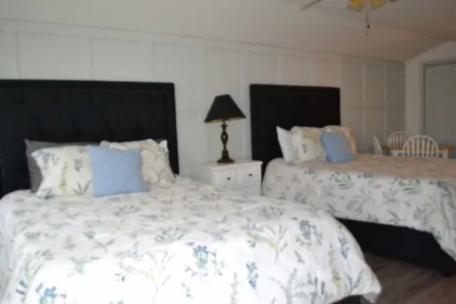 a kitchen with stainless steel appliances granite countertop a sink stove and white cabinets with wooden floor