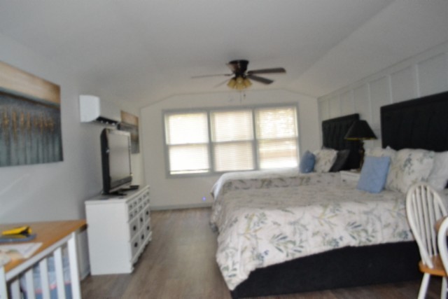 450 Cedar Hill Road Celina, TN 38551 - Photo 28 of 74 a bedroom with a large bed and a flat tv screen on a dresser