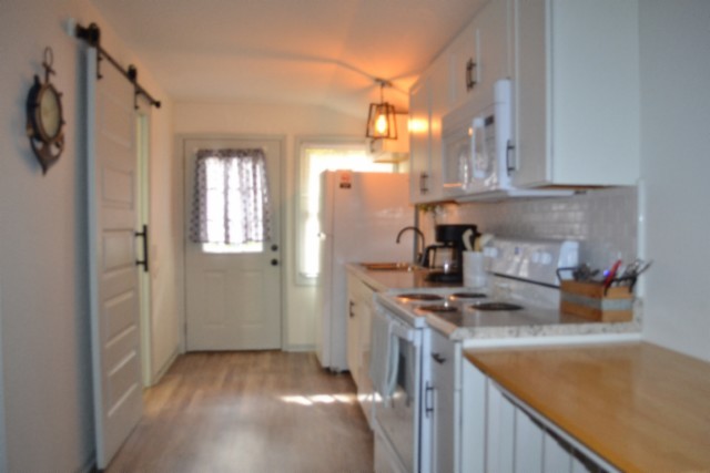 450 Cedar Hill Road Celina, TN 38551 - Photo 35 of 74 a kitchen that has a lot of cabinets in it