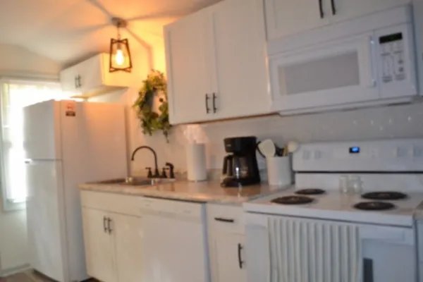 a view of a patio with table and chairs with wooden floor and fence
