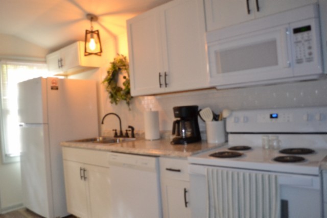 450 Cedar Hill Road Celina, TN 38551 - Photo 37 of 74 a kitchen with a sink a stove and cabinets