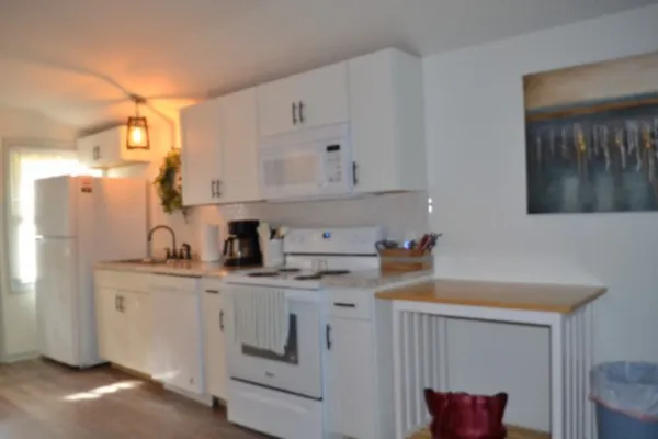 a backyard of a house with wooden floor and outdoor seating