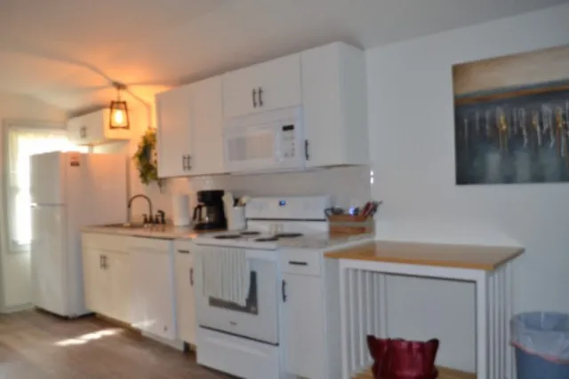 a backyard of a house with wooden floor and outdoor seating