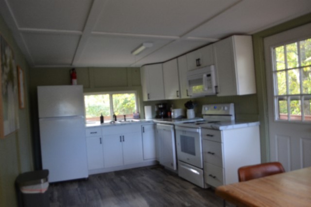 450 Cedar Hill Road Celina, TN 38551 - Photo 6 of 74 a kitchen with stainless steel appliances granite countertop a stove a sink and a refrigerator