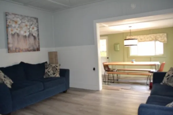 a kitchen with stainless steel appliances a dining table chairs and a chandelier