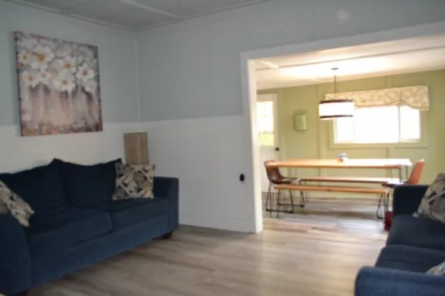 a kitchen with stainless steel appliances a dining table chairs and a chandelier