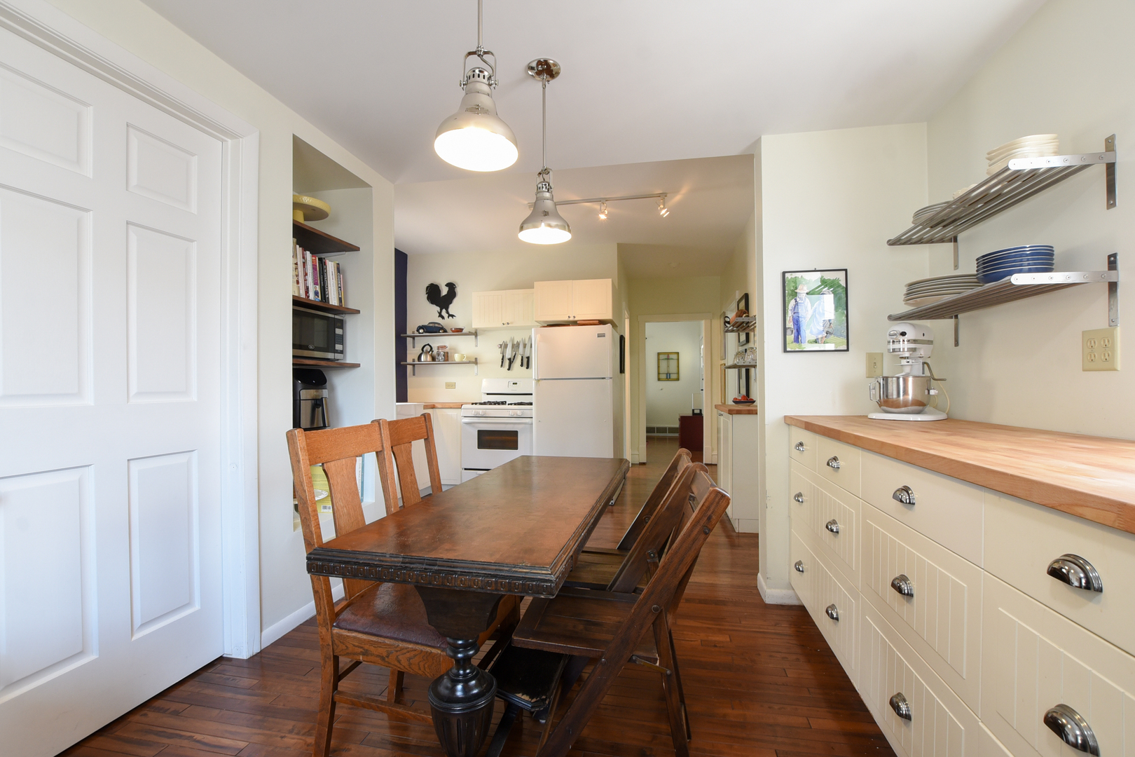 220 East Burlington Street Riverside, IL 60546 - Photo 13 of 31 a kitchen with stainless steel appliances kitchen island granite countertop a table chairs sink and cabinets