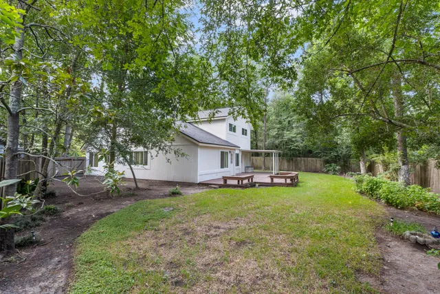 a view of a house with a yard and sitting area