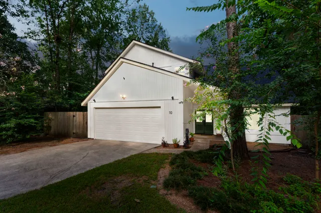 a backyard of a house with lots of green space and plants