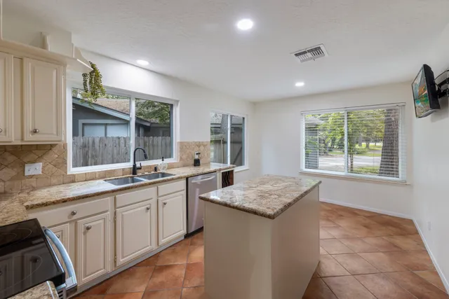 a kitchen with a sink stove and cabinets