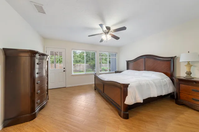 a bedroom with a large bed and a chandelier
