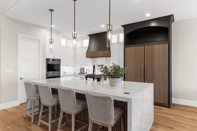 a kitchen with a dining table a sink and chairs