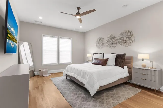 a bedroom with a large bed and a chandelier