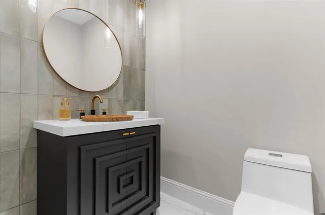 a living room with furniture and kitchen view