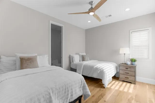 a bedroom with a bed and a lamp