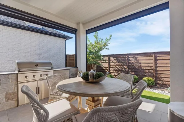 a view of a patio with table and chairs and potted plants