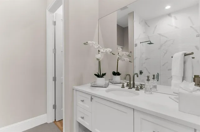 a bathroom with a sink a toilet and mirror
