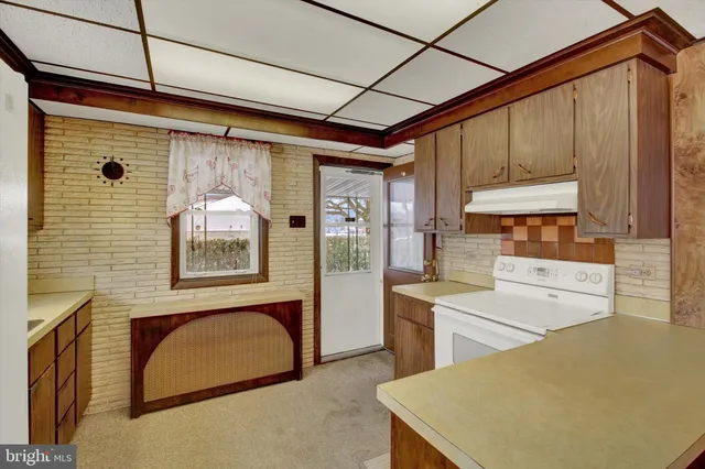 a kitchen with a refrigerator and a sink
